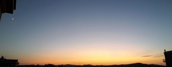 Low angle view of city at sunset