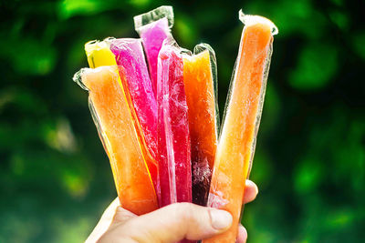 Close-up of hand holding ice cream