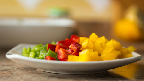 Close-up of chopped fruits in bowl on table