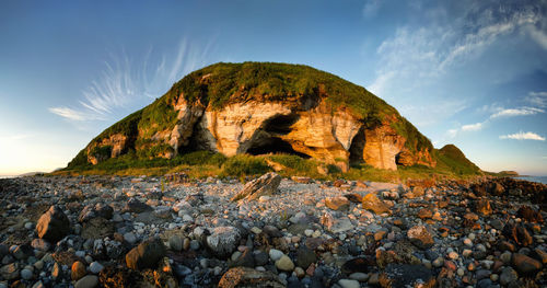 Rock formation on land against sky