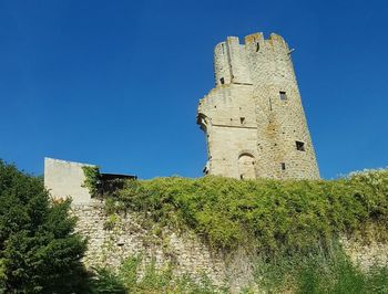 Low angle view of castle against clear blue sky