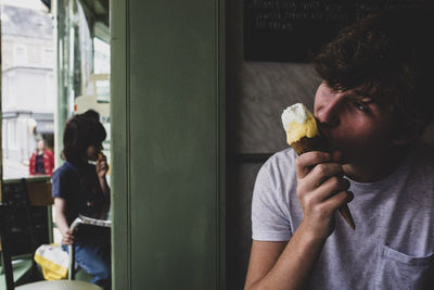 Young man eating ice cream