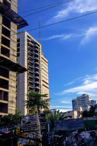 Buildings in city against blue sky