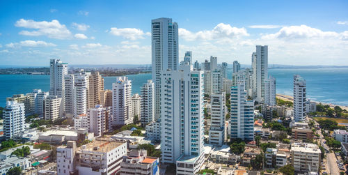 High angle view of modern buildings in city close to the beach
