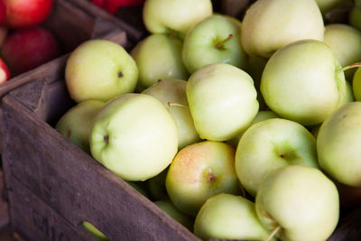 Close-up of ripe apples in wooden box