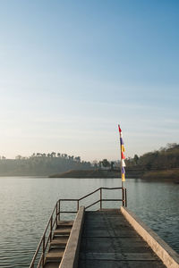 Pier over lake against sky