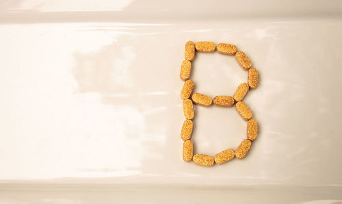 Close-up of letter b made with medicines on table