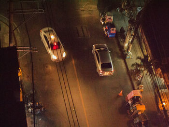 Vehicles on road in city at night