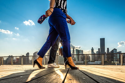 Full length of woman standing against sky