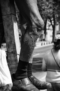 Low section of man standing in city