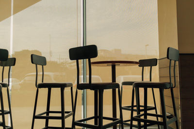 Silhouette of coffee table set in calm warm ambient coffee cafe.