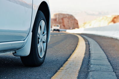 Close-up of car on road