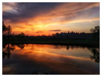 Scenic view of lake against romantic sky at sunset