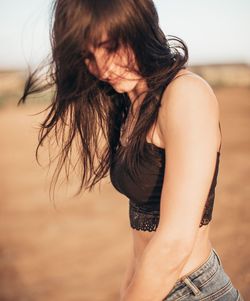 Midsection of woman with hands hair