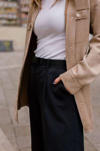 Midsection of woman standing on footpath