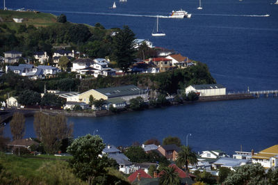 Boats in river with buildings in background