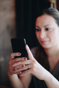 Midsection of woman using mobile phone