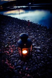 Lit candles on stones at night