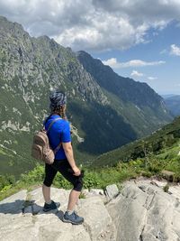 Full length of woman looking at mountains against sky