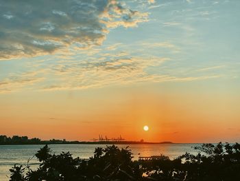 Scenic view of sea against orange sky