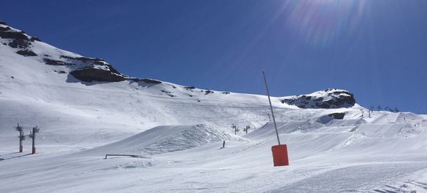 Snowcapped mountain against clear blue sky