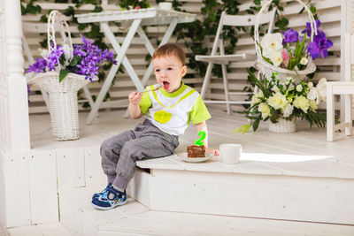 Full length of cute baby sitting on table