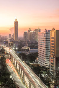 High angle view of illuminated buildings against sky during sunset