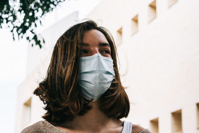 Portrait of woman covering face