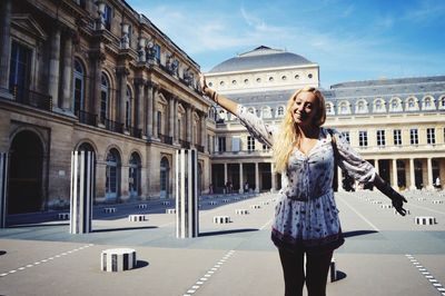 Young woman standing in front of building