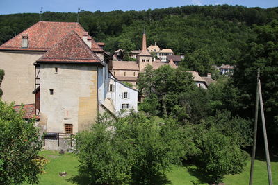 Houses in village amidst buildings in town