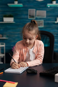 Girl sitting on table