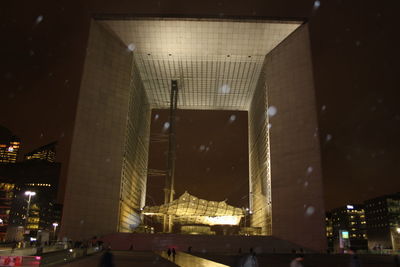 Low angle view of illuminated bridge at night