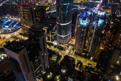 High angle view of city lit up at night