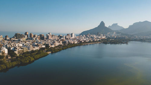 Panoramic view of city by sea against clear sky