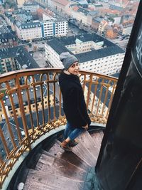 Woman on staircase above city