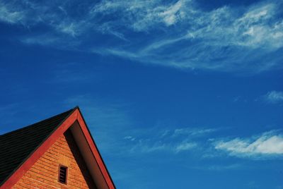 Low angle view of house against blue sky