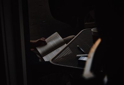 Cropped image of person reading book