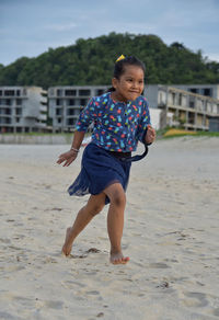 Full length portrait of girl running on beach