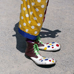 Low section of clown standing on road