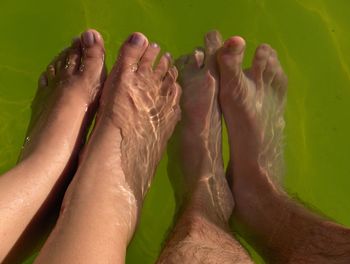 Low section of people relaxing in water