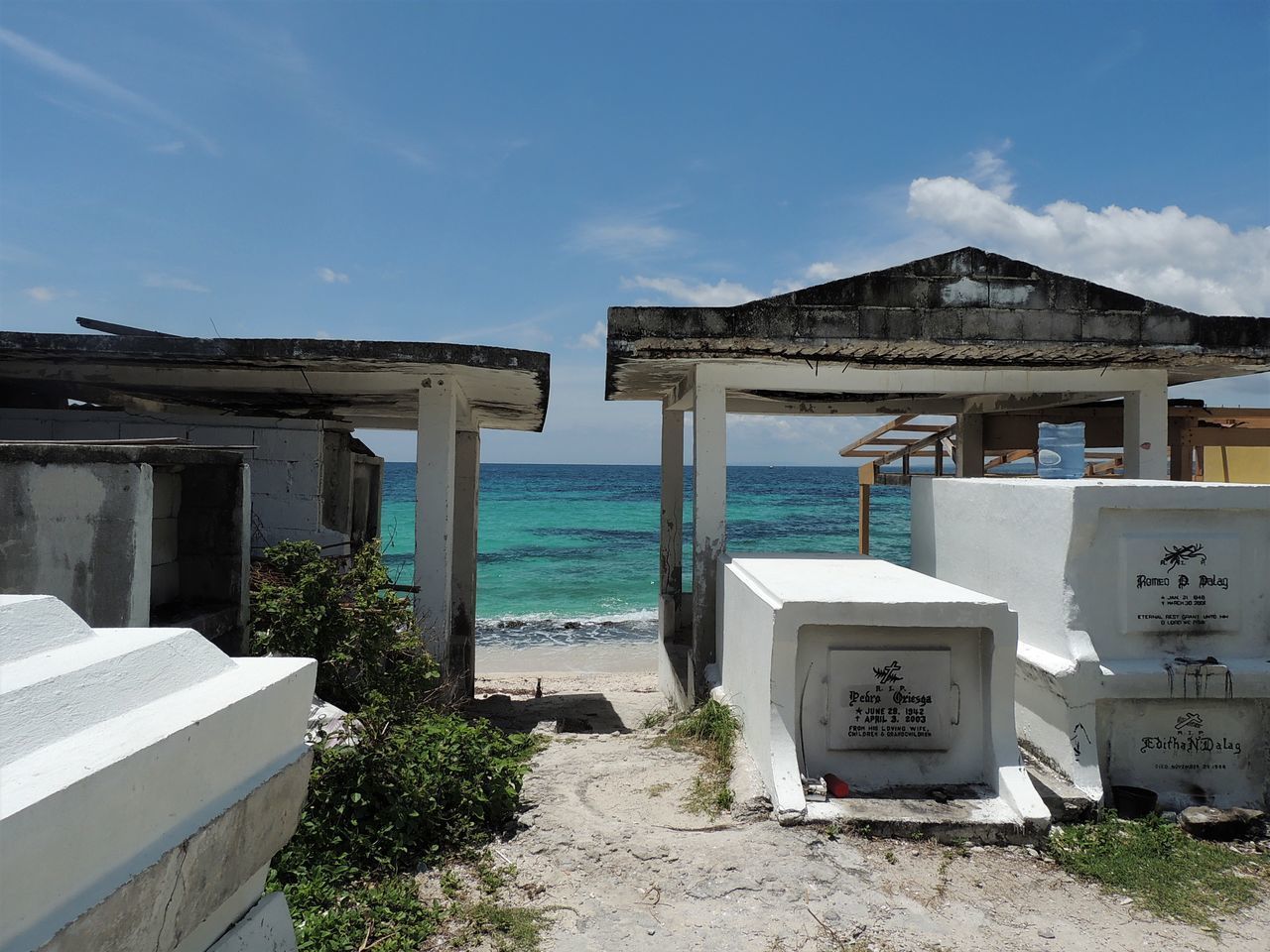 BUILT STRUCTURE BY BEACH AGAINST BLUE SKY