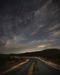 Scenic view of road against sky at night