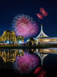 Low angle view of firework display at night