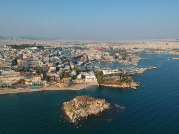 High angle view of townscape by sea against sky