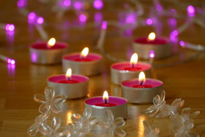 High angle view of lit candles on table