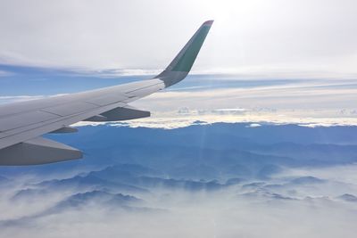 Aerial view of cloudscape over airplane wing