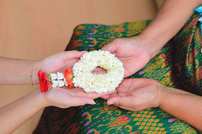 Midsection of woman holding bouquet of red rose