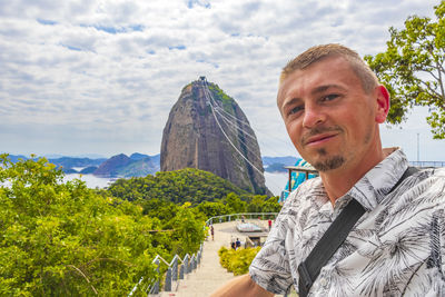 Tourist traveler poses at sugarloaf mountain rio de janeiro brazil.