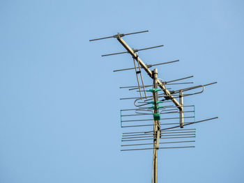 Low angle view of television aerial against clear sky