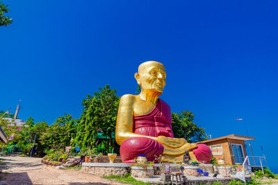 Low angle view of statue against blue sky